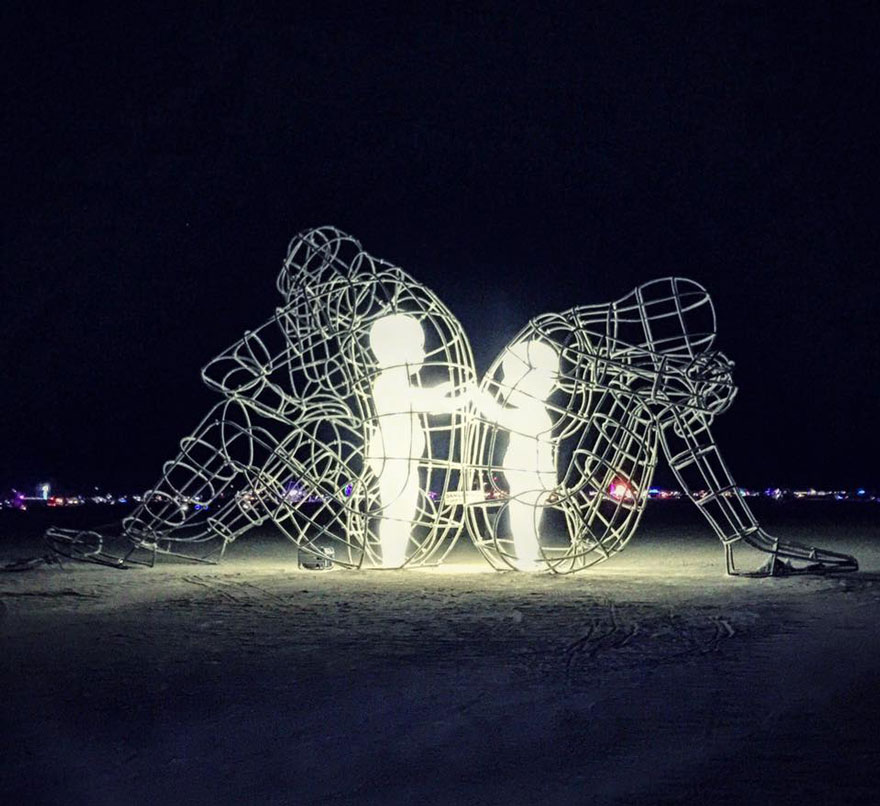 Burning Man Sculpture By Aleksandr Milov Reveals Inner Child Glowing Within Giant Wire-Framed Adult Bodies